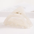 Detailed close-up of cream acetate geometric hair claw clip with golden metal spring - S140-2 Triangle Creamy White