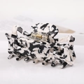 Detail of a rectangular acetate hair claw with black and white marble pattern and gold clip - S141-8 Ink Marble