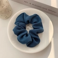 Detailed view of deep blue ribbed fabric scrunchie on a white ceramic plate tray - Dark Blue