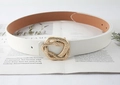 Detail of a white leather belt with a golden snake-shaped buckle on an open magazine - White