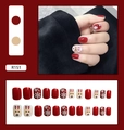 Detail of red Christmas press-on nails with reindeer and snowflake patterns - Wine Red Christmas Elk Style (R151)
