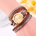 Geneva quartz watch with leopard print wrap-around band and gold dial on wrist - Brown