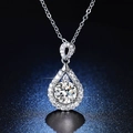 Macro shot of silver halo drop pendant necklace with sparkling round cut moissanite stone - Q026 Pear Halo 2ct