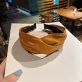 Detail of a vintage ginger leather knotted headband featuring a refined faux-leather texture - Turmeric