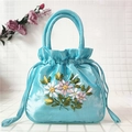 Close-up of light blue satin drawstring handbag with exquisite floral silk ribbon embroidery - Lake Blue