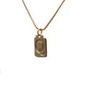 Close-up of a gold square pendant necklace featuring an embossed letter Q on a box chain - Letter Q