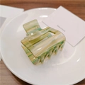 Minimalist square yellow-green striped acetate claw clip shown on a white plate - Water Ripple Green