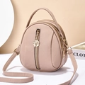 Litchi pattern leather crossbody backpack in nude pink with a golden rose zipper pull - Pink