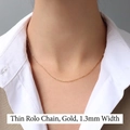 1.3mm thin cross chain necklace in 18K gold plated stainless steel on female model - Thin Cross Chain 40+5cm / Gold