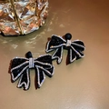 Elegant black bow earrings featuring shimmering crystals and a classic silver needle post - Black (925 Sterling Silver Earring Post)