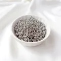Bulk silver jump rings for jewelry making displayed in a white ceramic bowl - 3mmx0.5mm (50 Pcs) / White Gold