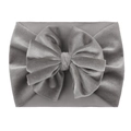 Detail shot of a grey velvet baby headband featuring a soft nylon large bow decoration - Gray