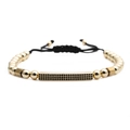 Adjustable woven bracelet with gold beads and black zircon tube on white background - Gold Bar