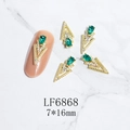 Macro shot of 7x16mm gold alloy nail art charm with green teardrop rhinestone - Gold Emerald Gem Style (6868)