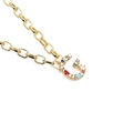 Detailed view of golden chain necklace with letter C pendant and colorful zircons - Letter G