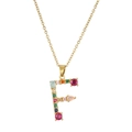 Detail of letter F pendant necklace with colorful gemstones on a gold-plated chain - Letter F