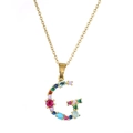 Close-up of letter G pendant with multi-color zircons and polished gold plating - Letter G