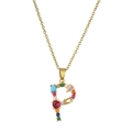 Detail of letter P necklace featuring colorful gemstones and a gold-plated chain - Letter P