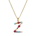 Macro shot of gold letter Z pendant with colorful multi-gemstone inlay on fine chain - Letter Z