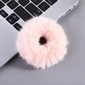 Cute light pink plush hair tie placed on a silver laptop keyboard background - Donut Scrunchie-Pink