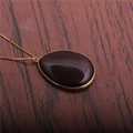 Elegant gold-plated waterdrop necklace with dark burgundy gemstone on rustic wood background - Amethyst Water Drop