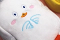 Macro shot of plush pencil case showing soft white fabric and detailed embroidery - White