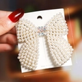 Detailed view of pearl bow hair clip with sparkling rhinestones, 7cm by 6.5cm size - S198-7 Large Pearl Bow