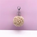 Detail of curly cream fur pom-pom keychain with silver lobster clasp on pink background - 1 Piece / Camel