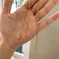 Detail of gold-plated cross chain necklace with lobster clasp held in hand - Stainless Steel Chain 50CM / Gold