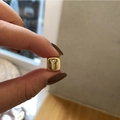 Macro detail of gold plated square charm with letter T featuring micro zircon inlay - Letter T / Gold