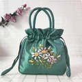 Detailed embroidery of colorful flowers on a dark green satin drawstring handbag - Green