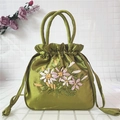 Detail of green satin handbag featuring floral ribbon embroidery and drawstring closure - Grass Green
