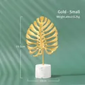 Golden monstera leaf metal ornament with white marble base for modern home decor - Monstera Leaf Small