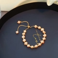 Baroque natural pearl bracelet in orange-pink with 14K gold plated adjustable slider - Pink