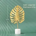Golden monstera leaf metal ornament with white marble base in large size, 25cm height - Monstera Leaf Large