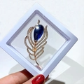 Elegant rose gold feather brooch with a deep blue crystal drop and micro-set stones - Teardrop Feather Style (XZ073)
