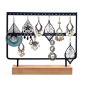 Black metal earring display stand with wooden base holding various styles of earrings - 46 Holes Black