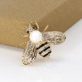 Macro shot of bee brooch featuring white pearls and black rhinestones on gold alloy - Golden Bee Pearl