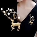 Detailed view and on-model display of gold reindeer brooch with pearls and crystals - Beige Deer Pearl Gold