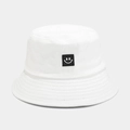 Detailed view of white cotton bucket hat with smile patch and reinforced stitched brim - White