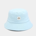 Detail of light blue cotton bucket hat featuring a minimalist embroidered smiley face patch - 58cm / Light Blue