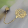 Golden hollowed rose metal bookmark with maple leaf pendant and chain detail - Rose