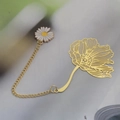 Golden metal leaf bookmark with hollow flower design and a white daisy pendant charm - Poppy