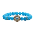 Macro detail of sky blue matte beads and gold Evil Eye charm with sparkling crystals - Blue