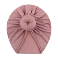 Pink cotton blend baby donut turban hat with top knot detail on a white background - Dusky Pink