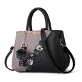 Fashionable floral embroidered handbag in black and grey with a grey pompom pendant - Grey Color-block