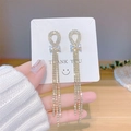 Eleganti orecchini a fiocco dorati con nappe scintillanti e dettagli in zirconi - Lunga Frangia con Fiocco in Strass Oro (E0118 Oro)