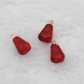 Deep red pomegranate seed resin charms with gold rings on white faux fur background - Dark Red