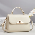 Detailed macro view of the cream leather texture and gold semicircular lock on this stylish bag - Off-white