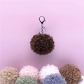 Close-up of soft curly faux fur plush ball keychain in multiple sweet pastel colors - 1 Piece / Dark Khaki
